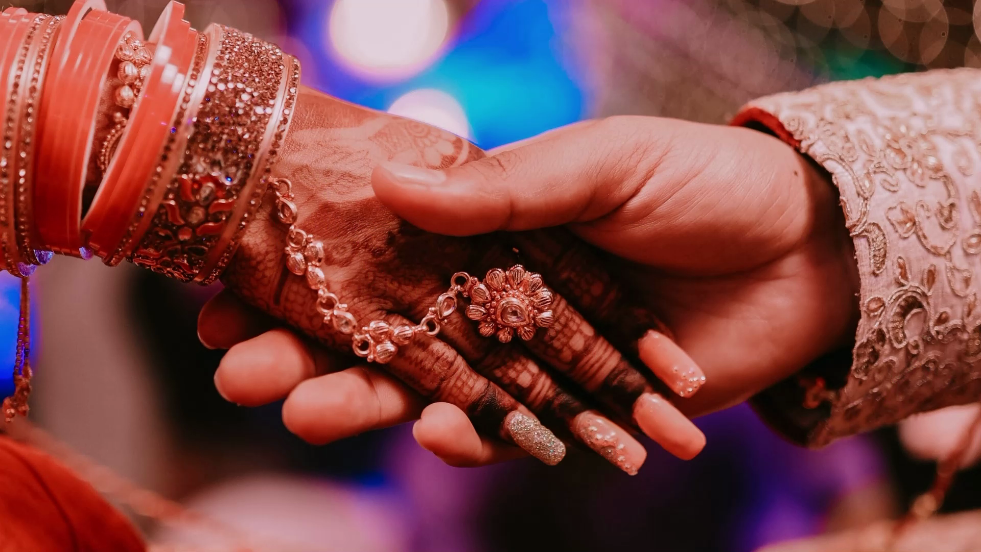Henna-adorned hands at a celebration at Ma'am Saab