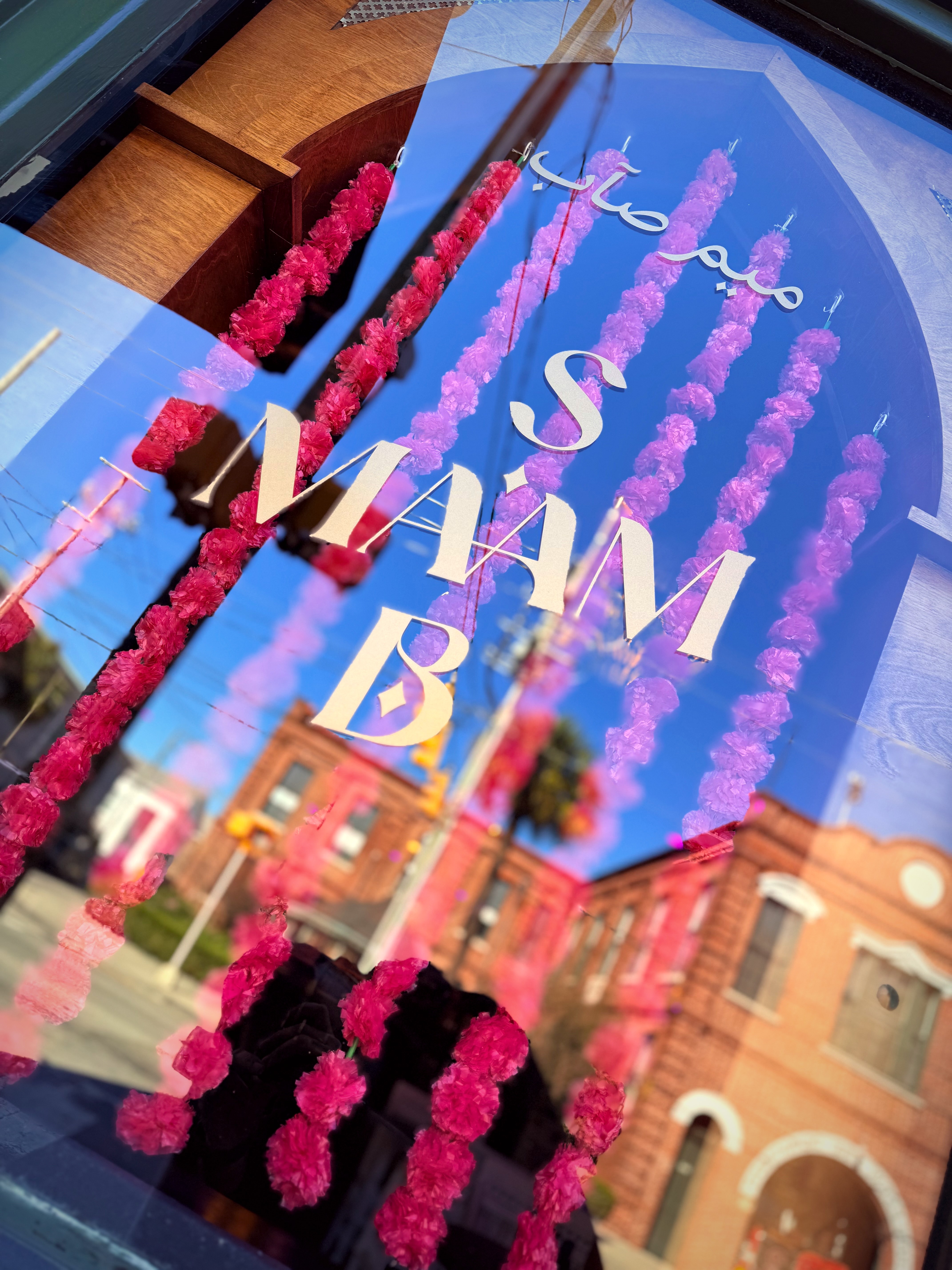 Ma'am Saab storefront window with marigold garlands